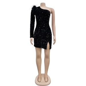Detail of black sequin dress featuring feather shoulder accents and shimmering texture
