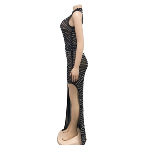Detail of black mesh evening dress featuring sparkling rhinestones and a side split cut
