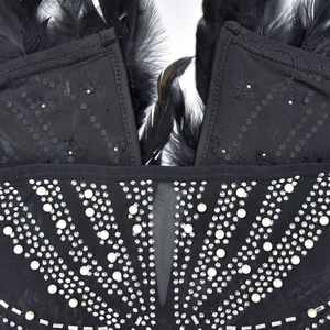 Detail of black mesh dress with luxury feathers, white pearls and sparkling rhinestones