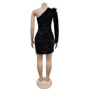 Detail of black sequined dress showing feather shoulder and side fringe accents