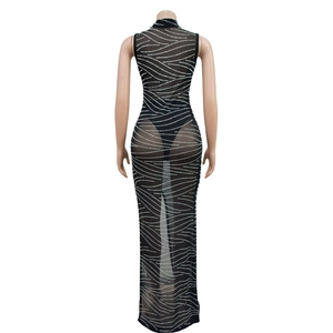 Close-up of black mesh sleeveless long dress with sparkling silver rhinestone wave patterns