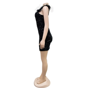 Detail of black sequined mini dress featuring elegant feather trim at the neckline