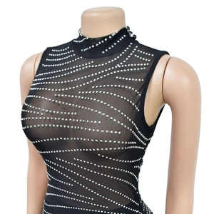 Detail of black mesh top featuring silver rhinestone wave patterns and high neckline