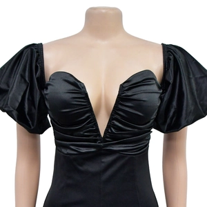 Detail of V-neckline with heart-shaped bodice and ruching on black mini dress