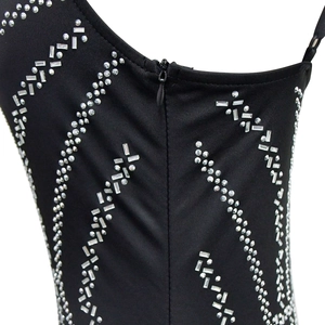 Detailed view of back zipper and geometric rhinestone patterns on a black dress
