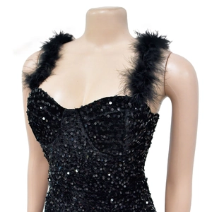 Detail shot of black sequin mini dress with elegant oversized feather shoulder straps