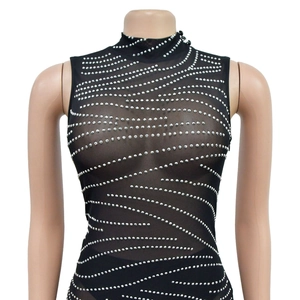 Detail of black mesh bodysuit with high neck and shimmering silver rhinestone wave pattern