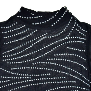 Close-up of black mesh mock neck top with wave-patterned silver rhinestones detailing