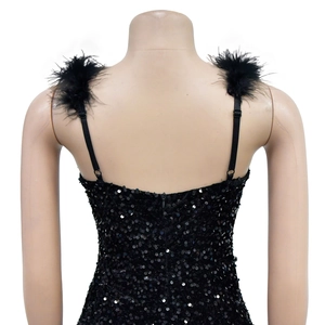 Detail of the back view of a black sequin dress featuring elegant feather shoulder straps