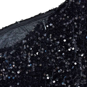 Detail of high-quality black sequins with invisible zipper on an elegant dress
