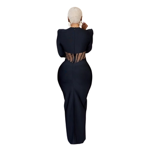 Detailed back view of long black dress featuring sheer mesh waist with vertical stripes