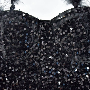 Detailed view of black sequin bodice with elegant feather trim and slim straps