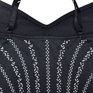 Detail of black V-neck dress featuring sparkling rhinestone patterns and adjustable straps