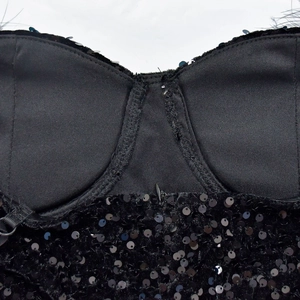 Detailed close-up of a black sequined sleeveless dress with molded cups and adjustable straps