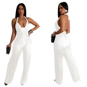 Detail of white halter jumpsuit featuring deep V-neck, backless cut and pleated texture