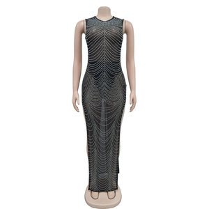 Detail of sheer black mesh dress featuring shimmering silver rhinestones in wavy patterns