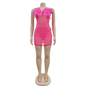 Detail of rose pink mini dress featuring mesh sequins and plush feather neckline trim