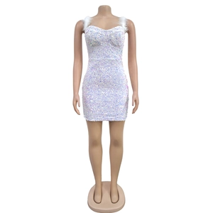 Detail of white sequin mini dress featuring sweetheart neckline and feather straps