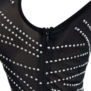 Close-up of black mesh fabric with silver rhinestone pattern and hidden zipper detail