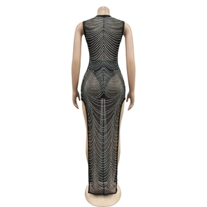 Close-up of sheer mesh evening gown featuring intricate silver rhinestone wavy patterns