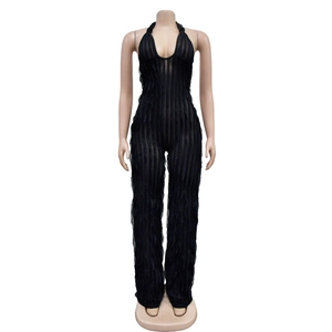 Detail of black pleated wide leg jumpsuit featuring deep V-neck and sheer fabric texture