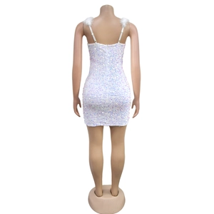 Close-up of white sequin mini dress featuring fluffy feather shoulder straps and slim fit