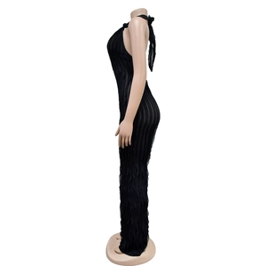 Detail of black halter backless jumpsuit featuring textured vertical pleated fabric