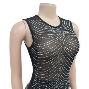Close-up of black mesh sleeveless dress with silver rhinestones in wavy patterns