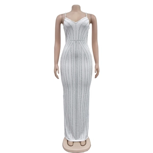 Detail of white tube top maxi dress featuring silver rhinestone vertical line patterns