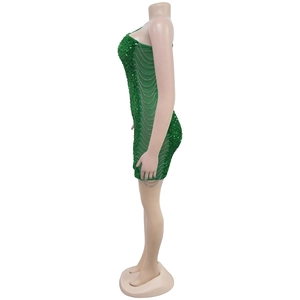 Detail of green sequin mini dress with side sheer mesh insert and silver fringe chains