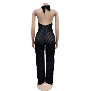 Macro shot of backless halter jumpsuit with black ruffle details and vertical stripes
