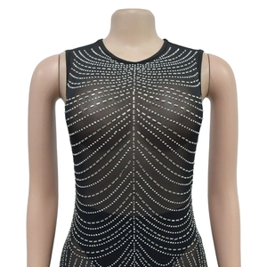 Detail of black mesh sleeveless dress featuring symmetrical silver rhinestone patterns