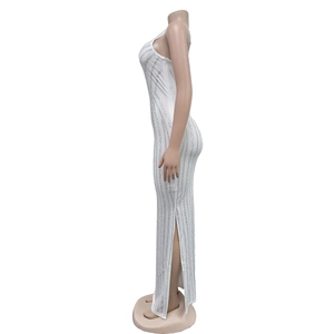 Detail of white slim evening dress with vertical silver rhinestones and side slit