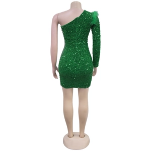 Detailed back view of green sequin dress with feather accents and fitted silhouette