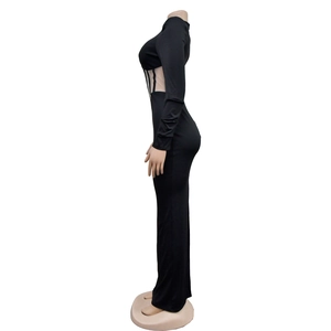 Detail view of the sheer mesh waist patchwork on this sexy black long sleeve maxi dress