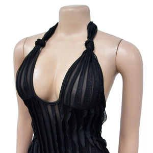 Detail of black pleated halter jumpsuit featuring a deep V-neck and mesh texture