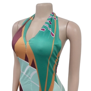 Close-up of geometric print halter dress featuring a deep V-neck and open back design