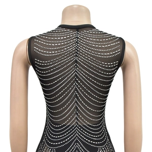 Detail of black mesh backless dress with radiant silver rhinestone wave patterns
