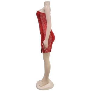 Detail of red sequined dress showing side slit and shimmering silver tassel chains