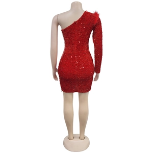 Detail view of red sequin dress back with one long sleeve and feather shoulder detail