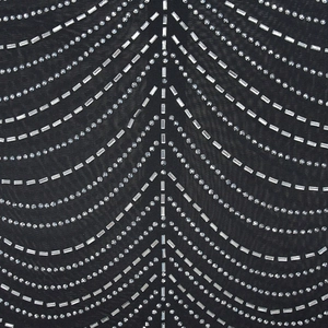 Detail of black mesh fabric with high-density silver rhinestones in V-shape patterns
