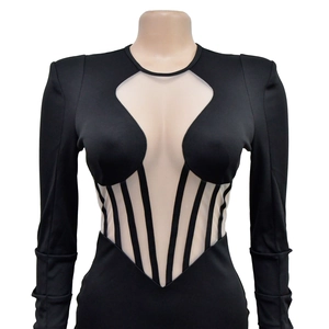 Detail of sheer mesh patchwork and striped fishbone effect on a black bodycon dress