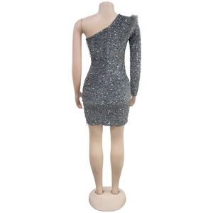 Detail of silver sequin dress showing feather shoulder trim and shimmering texture