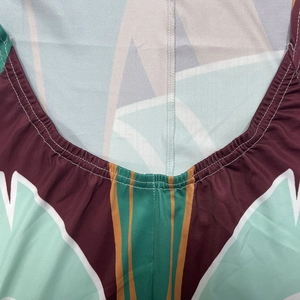 Detail of neckline with geometric print and double-needle stitching on the dress
