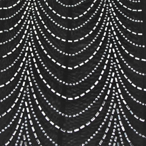 Detailed macro shot of shimmering rhinestones on black mesh fabric with wavy pattern