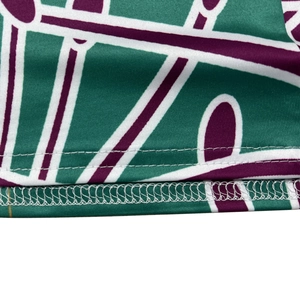 Detailed close-up showing reinforced double-needle hem and overlock stitching on floral dress