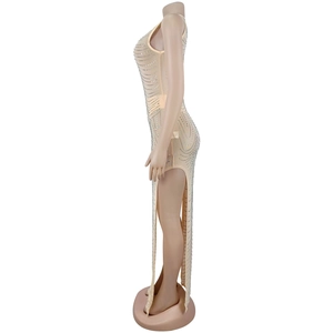 Detail of nude mesh dress with silver rhinestones and high side slit design
