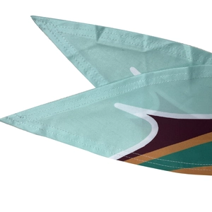 Close-up of mint green printed fabric showing neat edge stitching and geometric patterns