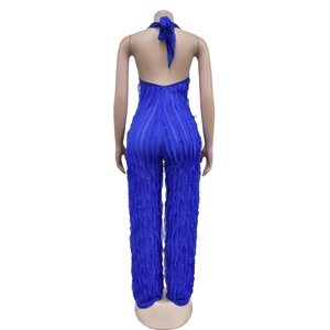Detail of royal blue backless jumpsuit featuring vertical ruffles and halter tie closure