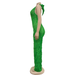 Detail of bright green pleated jumpsuit featuring a ruffled texture and halter neckline